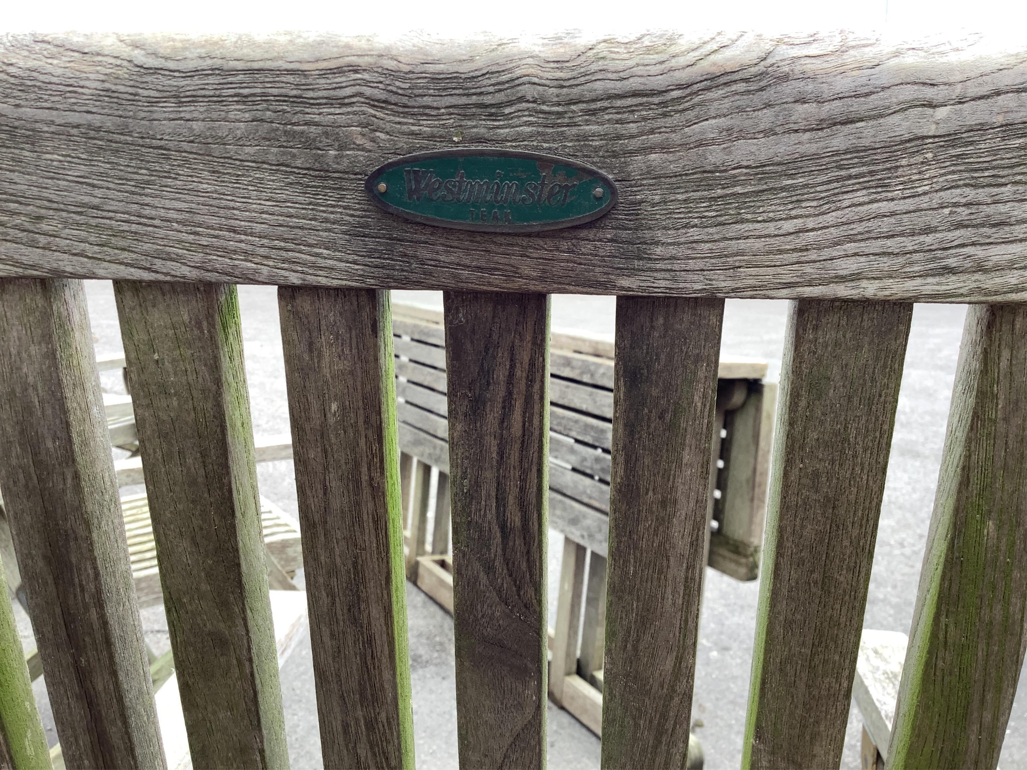 A weathered teak rectangular folding garden table, width 157cm and four folding chairs